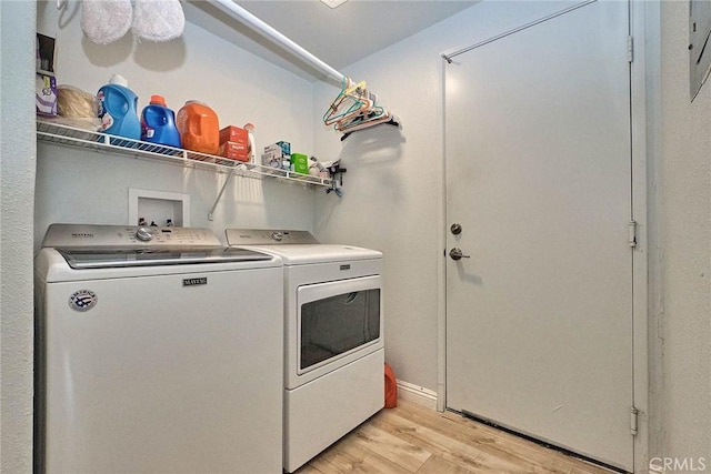 25401 Holly Beach Dr, Saugus, CA 91350 - laundry area featuring washer and dryer and light wood-type flooring