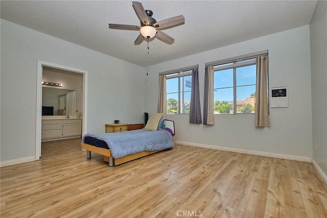 25401 Holly Beach Dr, Saugus, CA 91350 - bedroom with light wood-style flooring, ensuite bathroom, and a ceiling fan
