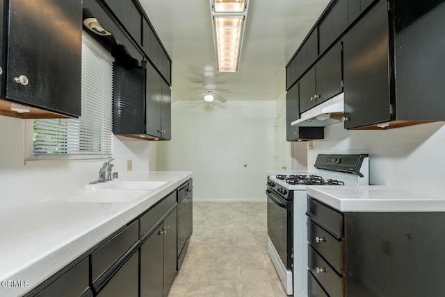 3910 Vista Ct, La Crescenta, CA 91214 - kitchen with gas stove, under cabinet range hood, black dishwasher, a ceiling fan, and light countertops