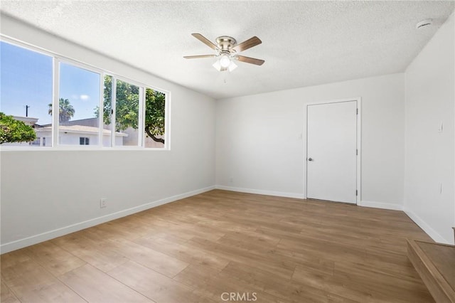 1410 Gulf Ave, Wilmington, CA 90744 - spare room featuring ceiling fan, a textured ceiling, and light wood-type flooring