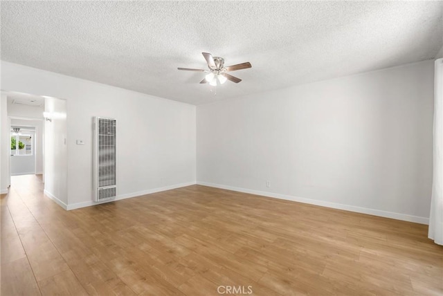 1410 Gulf Ave, Wilmington, CA 90744 - unfurnished room featuring a heating unit, a ceiling fan, light wood-style floors, and a textured ceiling
