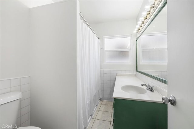 1410 Gulf Ave, Wilmington, CA 90744 - full bathroom featuring tile walls, tile patterned floors, vanity, a wainscoted wall, and shower / tub combo