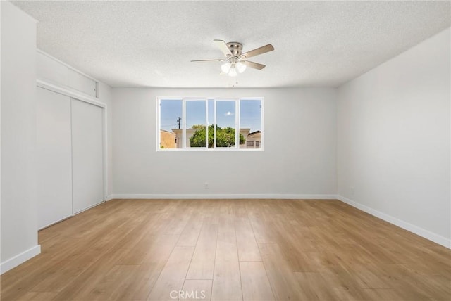 1410 Gulf Ave, Wilmington, CA 90744 - unfurnished bedroom with light wood-style flooring, a closet, a textured ceiling, and ceiling fan