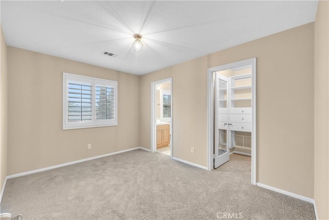 284 Tustin Field Dr, Tustin, CA 92782 - unfurnished bedroom with carpet flooring, a walk in closet, a closet, and ensuite bathroom