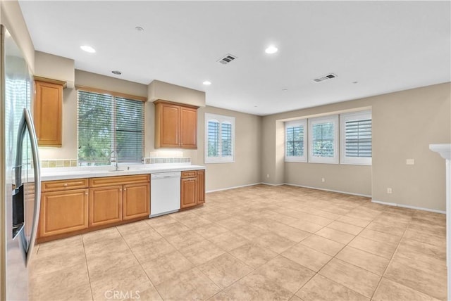 284 Tustin Field Dr, Tustin, CA 92782 - kitchen with dishwasher, stainless steel fridge with ice dispenser, light countertops, light tile patterned floors, and recessed lighting
