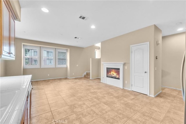 284 Tustin Field Dr, Tustin, CA 92782 - unfurnished living room featuring stairs, a glass covered fireplace, light tile patterned floors, and recessed lighting