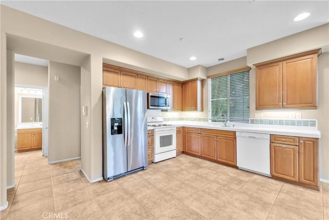 284 Tustin Field Dr, Tustin, CA 92782 - kitchen featuring appliances with stainless steel finishes, light tile patterned floors, recessed lighting, and brown cabinets