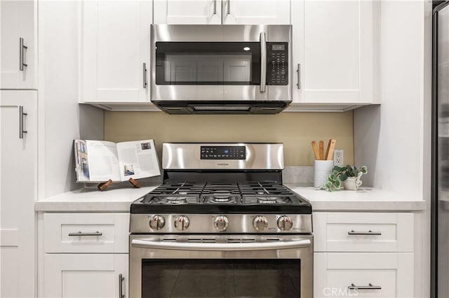 7021 Shoshone Ave, Lake Balboa, CA 91406 - kitchen with appliances with stainless steel finishes, light countertops, and white cabinets