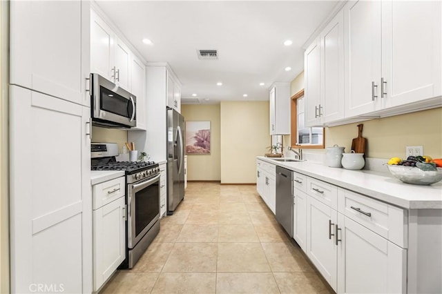 7021 Shoshone Ave, Lake Balboa, CA 91406 - kitchen featuring appliances with stainless steel finishes, recessed lighting, light countertops, white cabinets, and light tile patterned floors