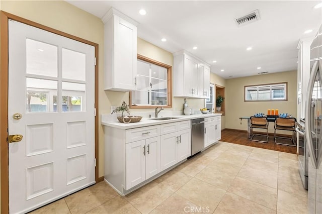 7021 Shoshone Ave, Lake Balboa, CA 91406 - kitchen featuring stainless steel appliances, light countertops, white cabinets, light tile patterned floors, and recessed lighting
