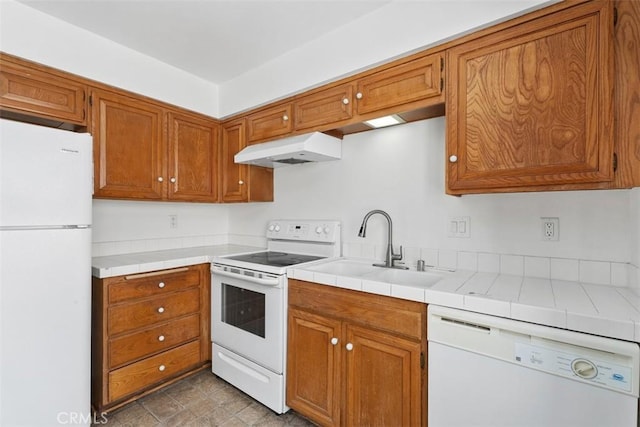 6150 Montecito Dr Unit 6, Palm Springs, CA 92264 - kitchen with white appliances, under cabinet range hood, and brown cabinetry