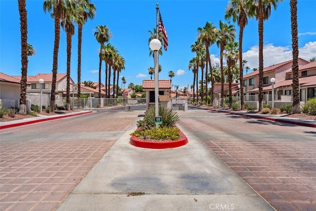 6150 Montecito Dr Unit 6, Palm Springs, CA 92264 - view of decorative road featuring a residential view, curbs, a gate, and street lights