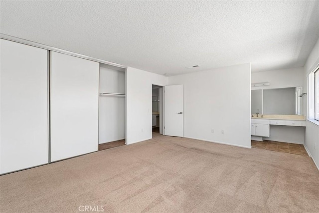 6150 Montecito Dr Unit 6, Palm Springs, CA 92264 - unfurnished bedroom featuring carpet floors, a textured ceiling, ensuite bath, and an office area