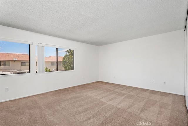 6150 Montecito Dr Unit 6, Palm Springs, CA 92264 - carpeted empty room with a textured ceiling and baseboards