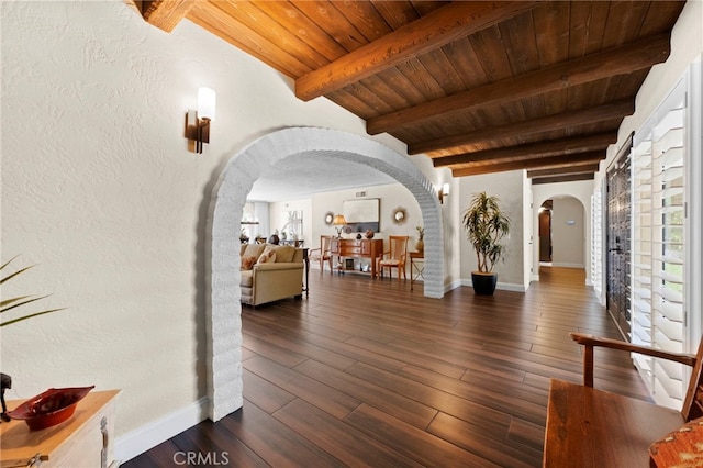 9430 Valley View St, Rancho Cucamonga, CA 91737 - entrance foyer with arched walkways, a wooden ceiling with exposed beams, a textured wall, and dark wood-type flooring