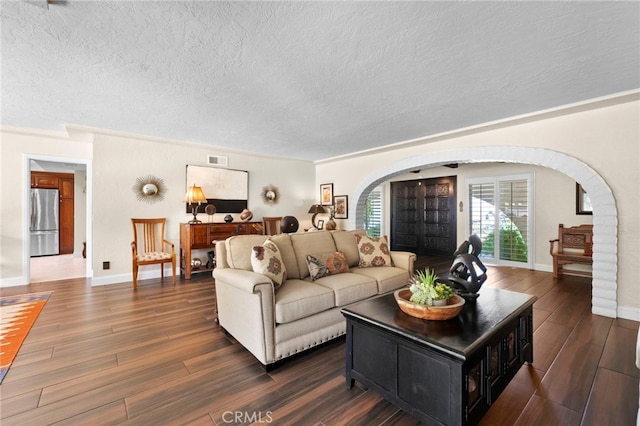 9430 Valley View St, Rancho Cucamonga, CA 91737 - living room featuring arched walkways, wood finished floors, and a textured ceiling