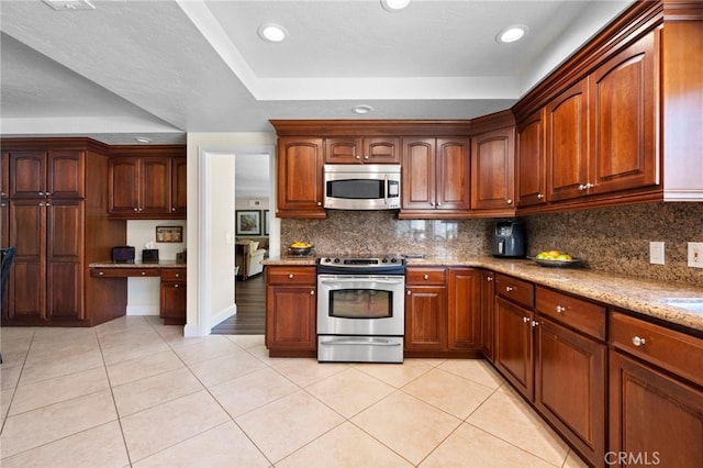 9430 Valley View St, Rancho Cucamonga, CA 91737 - kitchen with appliances with stainless steel finishes, light stone counters, tasteful backsplash, light tile patterned flooring, and recessed lighting