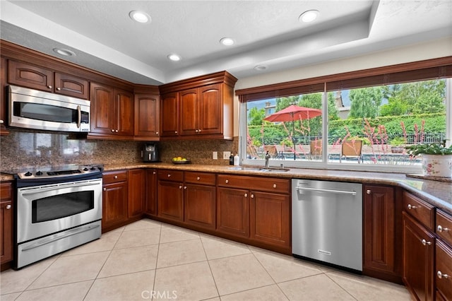 9430 Valley View St, Rancho Cucamonga, CA 91737 - kitchen with stainless steel appliances, tasteful backsplash, light tile patterned floors, recessed lighting, and stone counters