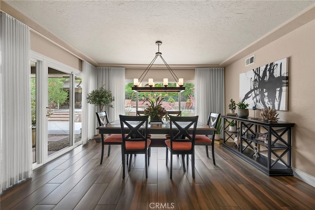9430 Valley View St, Rancho Cucamonga, CA 91737 - dining space featuring a textured ceiling, dark wood-type flooring, and a chandelier
