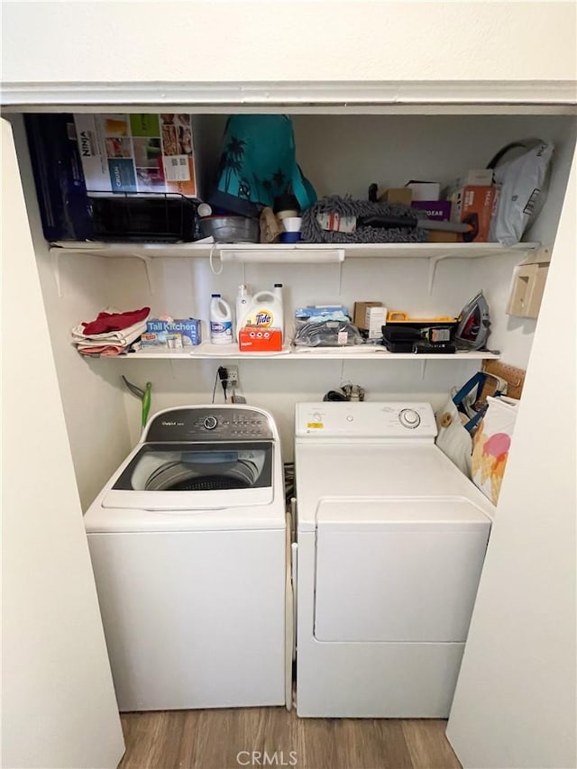 5310 Zelzah Ave Unit 312, Encino, CA 91316 - washroom with washing machine and clothes dryer and wood finished floors