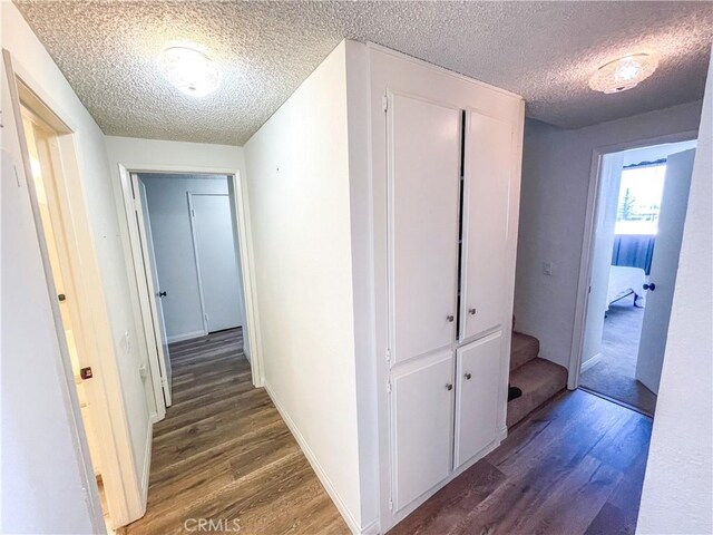 5310 Zelzah Ave Unit 312, Encino, CA 91316 - corridor featuring a textured ceiling, wood finished floors, and stairs