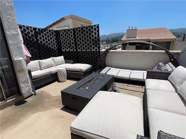 5310 Zelzah Ave Unit 312, Encino, CA 91316 - view of patio featuring an outdoor living space with a fire pit and a mountain view
