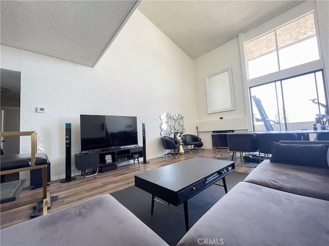 5310 Zelzah Ave Unit 312, Encino, CA 91316 - living area featuring a textured ceiling, wood finished floors, a textured wall, and vaulted ceiling
