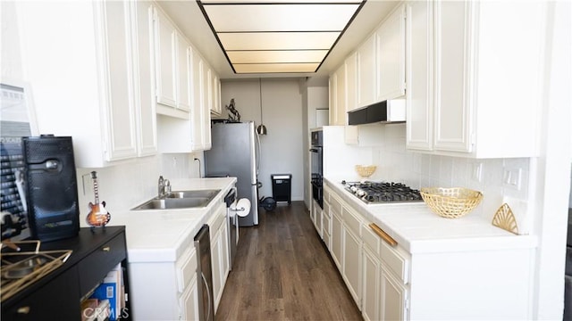5310 Zelzah Ave Unit 312, Encino, CA 91316 - kitchen with appliances with stainless steel finishes, light countertops, backsplash, and dark wood-style flooring
