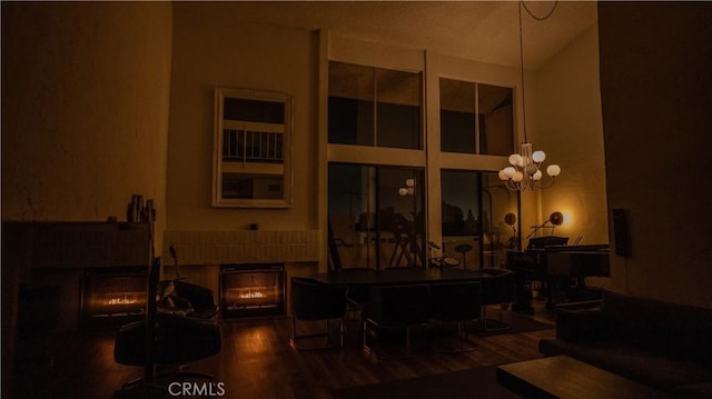 5310 Zelzah Ave Unit 312, Encino, CA 91316 - living room with a fireplace, wood finished floors, and a chandelier