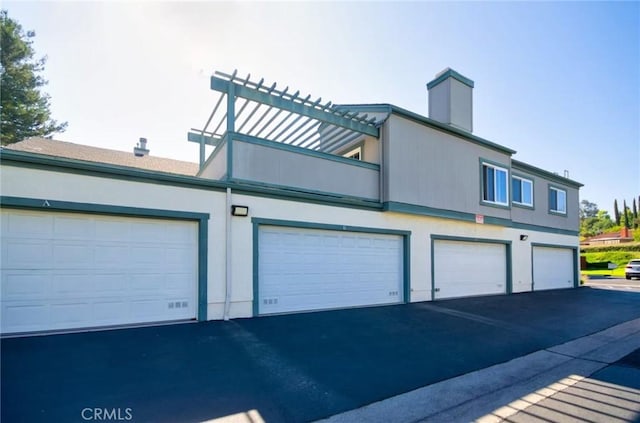 1116 Cleghorn Dr Unit B, Diamond Bar, CA 91765 - view of home's exterior with a chimney, stucco siding, and a balcony