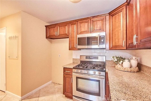 1116 Cleghorn Dr Unit B, Diamond Bar, CA 91765 - kitchen featuring appliances with stainless steel finishes, brown cabinets, tasteful backsplash, and light stone countertops