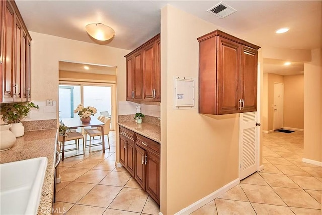 1116 Cleghorn Dr Unit B, Diamond Bar, CA 91765 - kitchen with light tile patterned flooring, recessed lighting, light stone counters, tasteful backsplash, and brown cabinetry