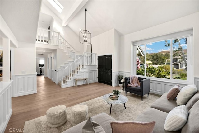 21210 Twin Oak, Yorba Linda, CA 92886 - living area featuring a decorative wall, stairs, light wood finished floors, high vaulted ceiling, and beam ceiling