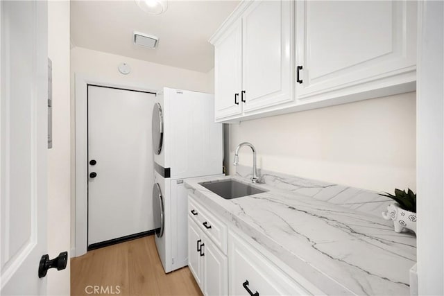 21210 Twin Oak, Yorba Linda, CA 92886 - washroom featuring stacked washer / dryer, cabinet space, and light wood-type flooring