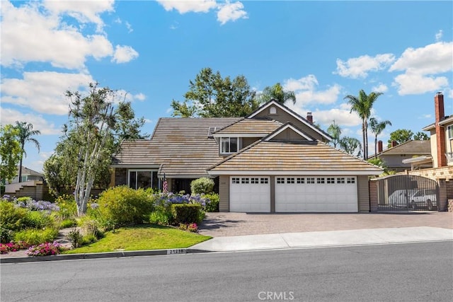 21210 Twin Oak, Yorba Linda, CA 92886 - traditional-style house featuring driveway, a gate, an attached garage, and a tiled roof