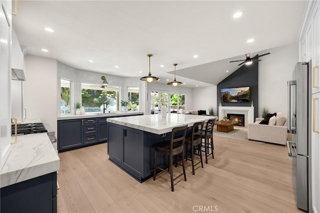 21210 Twin Oak, Yorba Linda, CA 92886 - kitchen with light wood-style flooring, recessed lighting, open floor plan, a lit fireplace, and high end refrigerator