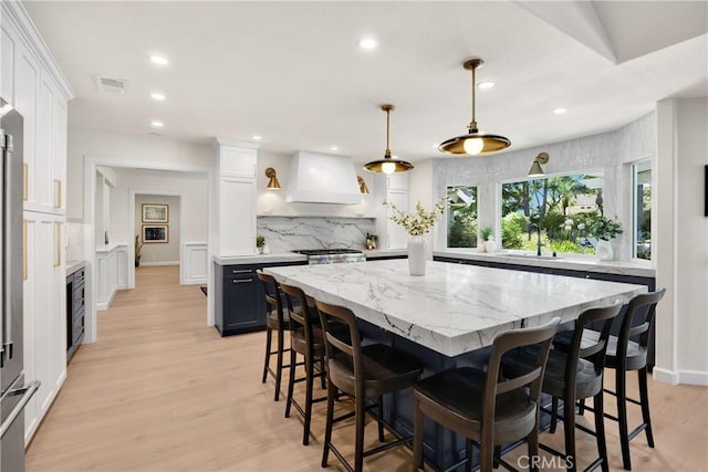21210 Twin Oak, Yorba Linda, CA 92886 - kitchen featuring custom range hood, tasteful backsplash, white cabinetry, a center island, and recessed lighting