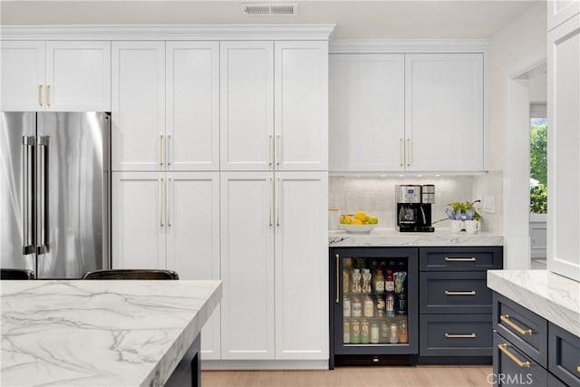 21210 Twin Oak, Yorba Linda, CA 92886 - indoor dry bar featuring high quality fridge, tasteful backsplash, light wood-style floors, and beverage cooler