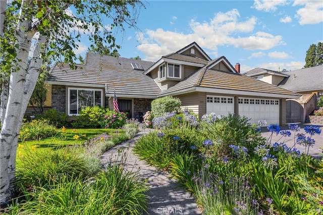 21210 Twin Oak, Yorba Linda, CA 92886 - traditional-style home featuring an attached garage, a tiled roof, stone siding, and driveway