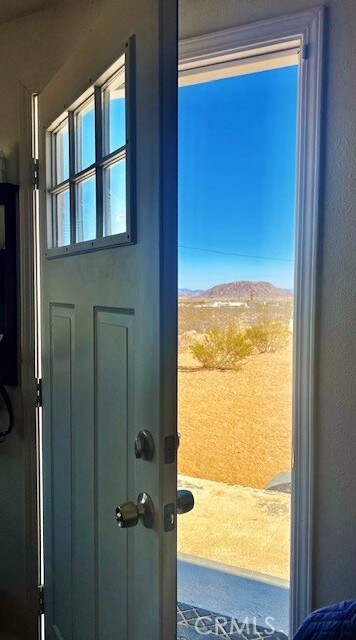 56133 Jesse Rd, Landers, CA 92285 - doorway featuring a mountain view and a textured wall