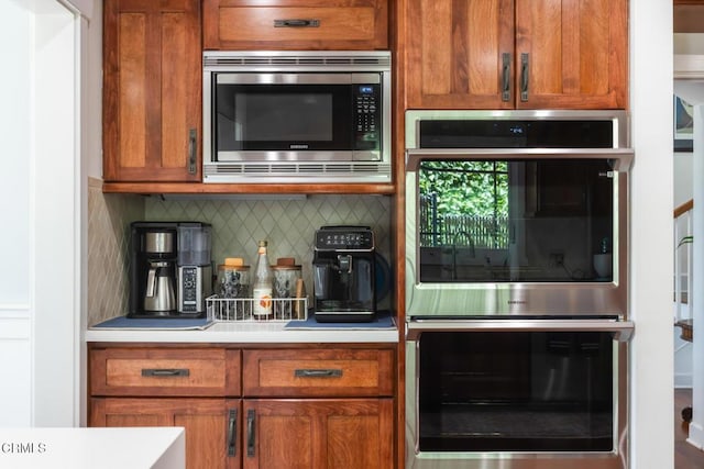 3626 Saint Elizabeth Rd, Glendale, CA 91206 - kitchen with stainless steel appliances, decorative backsplash, light countertops, and brown cabinets