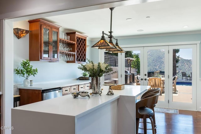 3626 Saint Elizabeth Rd, Glendale, CA 91206 - kitchen featuring light countertops, french doors, glass insert cabinets, dark wood finished floors, and a kitchen island