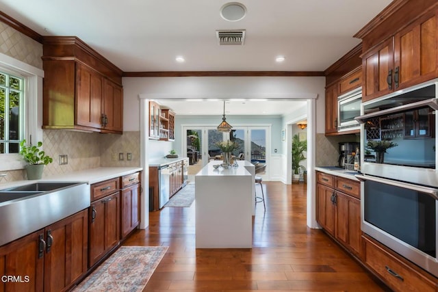3626 Saint Elizabeth Rd, Glendale, CA 91206 - kitchen with appliances with stainless steel finishes, crown molding, healthy amount of natural light, dark wood finished floors, and recessed lighting