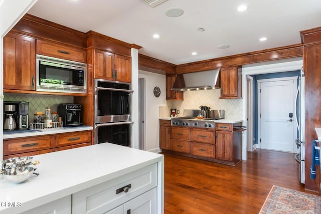 3626 Saint Elizabeth Rd, Glendale, CA 91206 - kitchen featuring stainless steel appliances, wall chimney exhaust hood, tasteful backsplash, light countertops, and recessed lighting