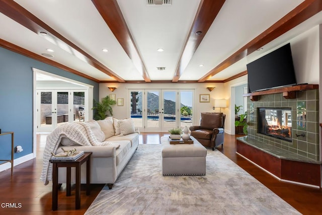 3626 Saint Elizabeth Rd, Glendale, CA 91206 - living area with french doors, a tile fireplace, recessed lighting, wood finished floors, and beamed ceiling