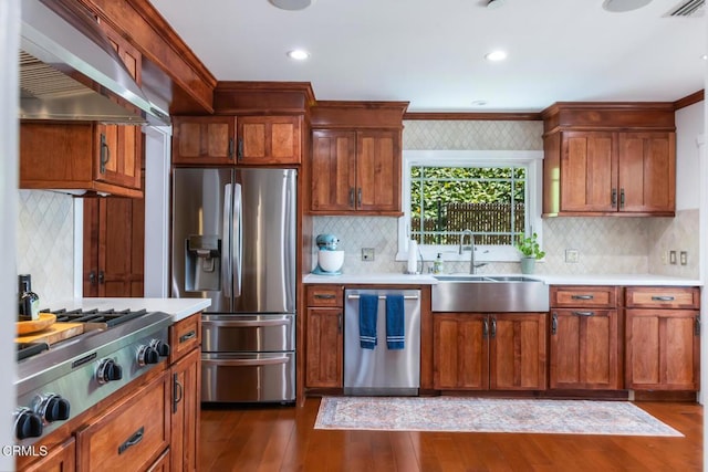 3626 Saint Elizabeth Rd, Glendale, CA 91206 - kitchen with appliances with stainless steel finishes, ventilation hood, light countertops, dark wood-style floors, and recessed lighting