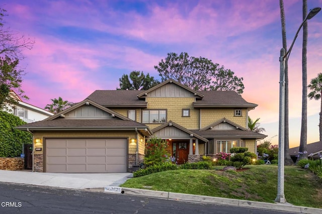 3626 Saint Elizabeth Rd, Glendale, CA 91206 - craftsman-style home with driveway, an attached garage, a lawn, and stone siding