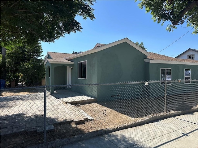 2311 5th St, Riverside, CA 92507 - view of home's exterior featuring stucco siding and roof with shingles