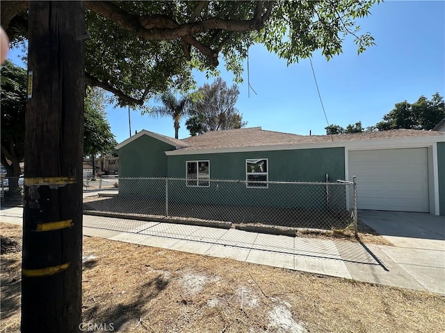 2311 5th St, Riverside, CA 92507 - view of front of house with driveway, a garage, stucco siding, and roof with shingles