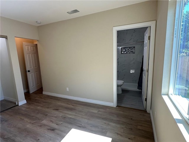 2311 5th St, Riverside, CA 92507 - unfurnished bedroom featuring wood finished floors, multiple windows, and ensuite bathroom